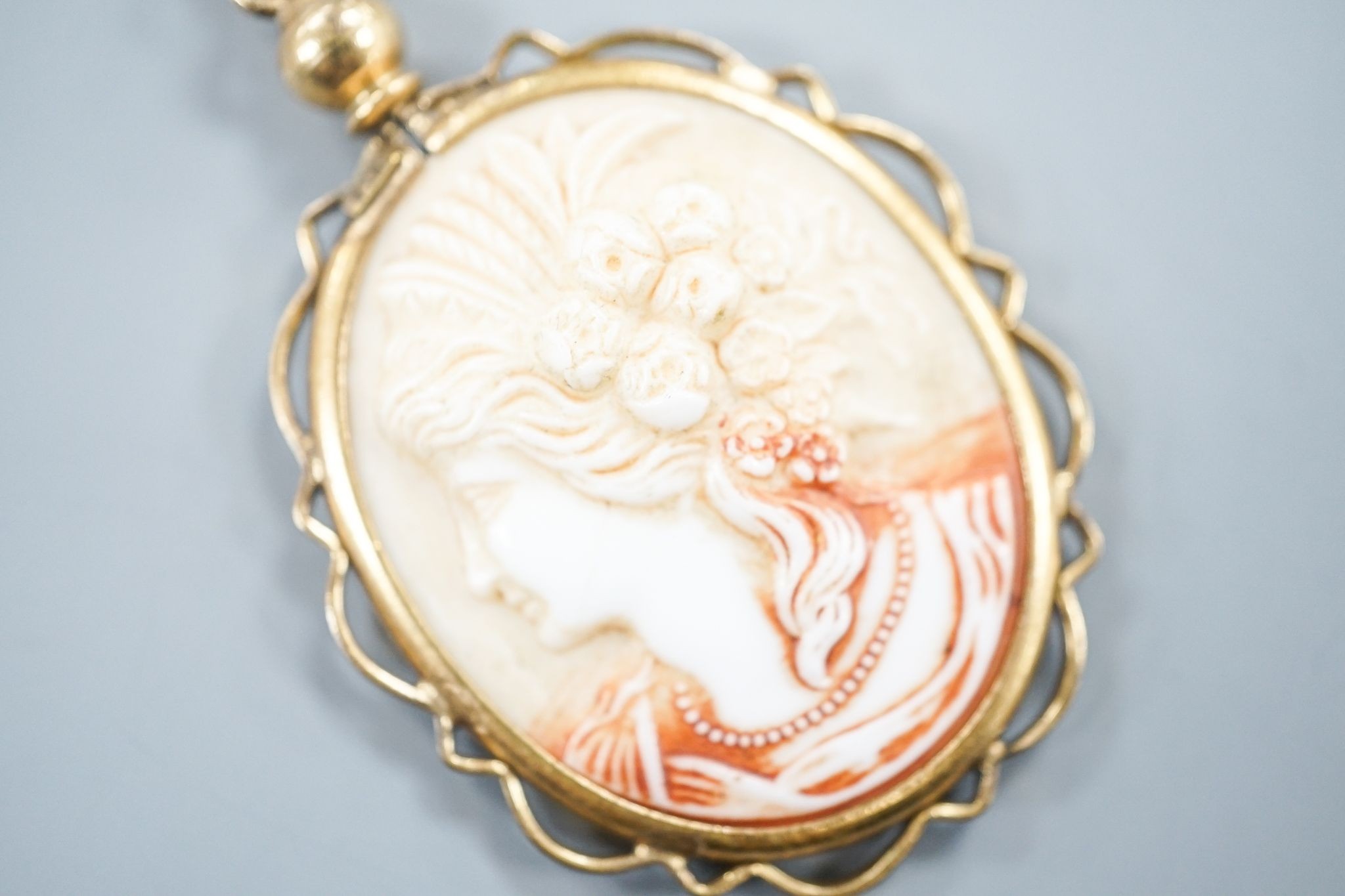 A gilt metal mounted oval ceramic? cameo pendant, 35mm.